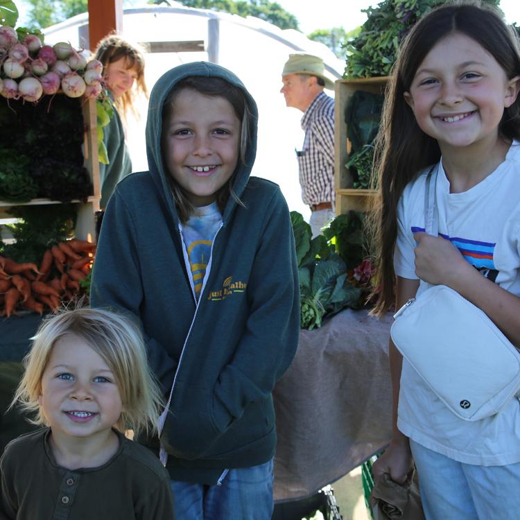 Youngsters help with the farm chores at MercyMed in Columbus. Photo by Borden Black