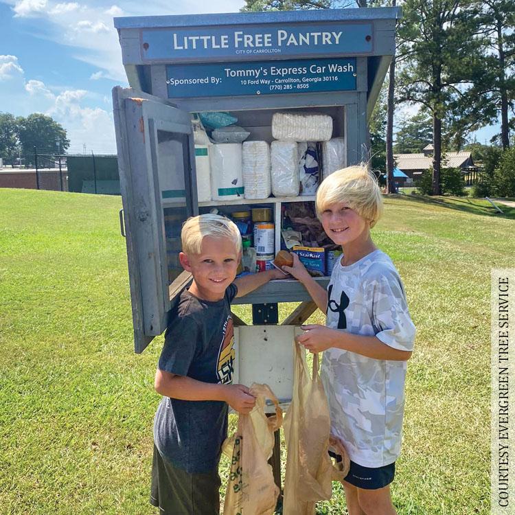 Youngsters restock a Little Free Pantry in Carrollton