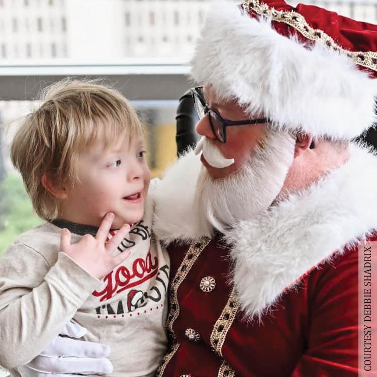 Santa Bradley holds a child with Down Syndrome