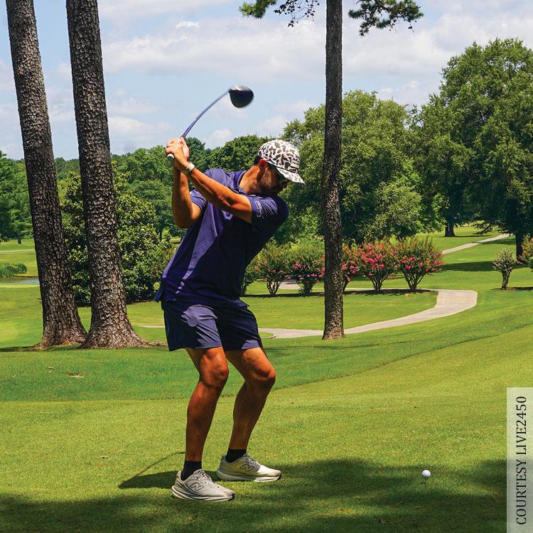 man hitting golf ball