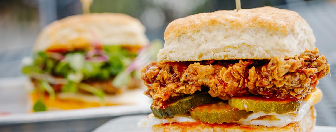 The Farmcart's huge Firebird Biscuit is stacked with fried chicken, pickles and more
