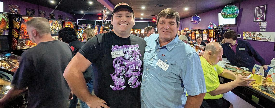 Pinball champ Dalton Ely and his dad Stephen pause before a tournament at Portal Pinball in Acworth