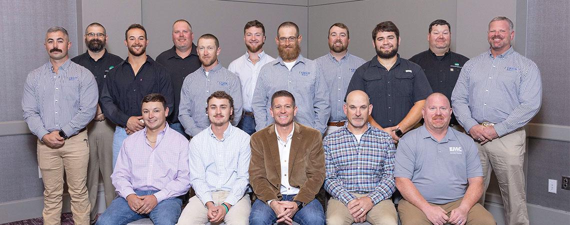 two rows of men pose for photo