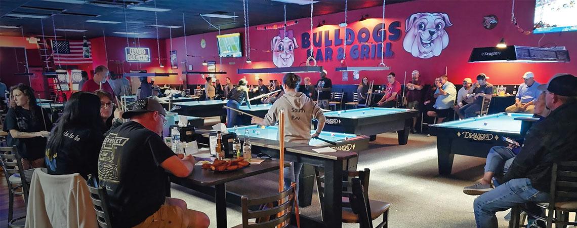 people playing pool in a pool hall